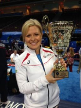 Dr. Kells holding world wrestling championship trophy